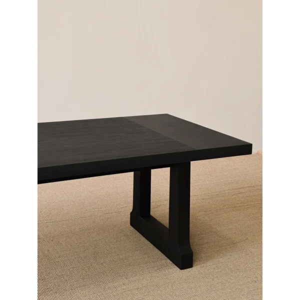 Matte Black Brushed Oak Long Dining Table in black — in a room setting
