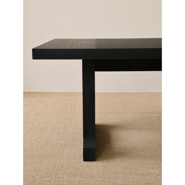 Matte Black Brushed Oak Long Dining Table in black — in a room setting