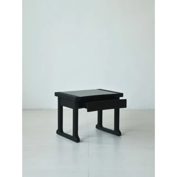 Matte Black Brushed Oak Nightstand on Sled Base in black — in a room setting
