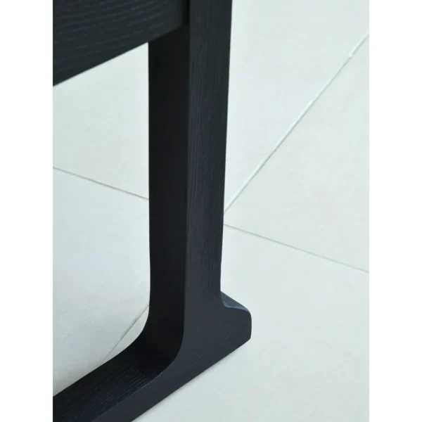 Matte Black Brushed Oak Nightstand on Sled Base in black — in a room setting
