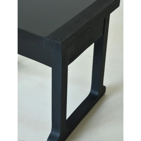 Matte Black Brushed Oak Nightstand on Sled Base in black — in a room setting