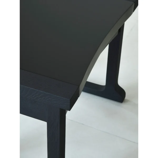 Matte Black Brushed Oak Nightstand on Sled Base in black — in a room setting