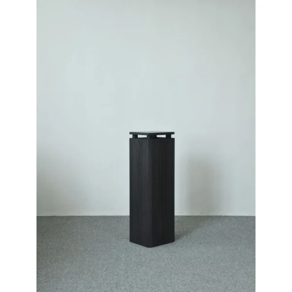 Sandblasted Cedar Pedestal with Stone Top, 110 cm in black — in a room setting