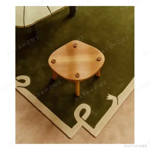 Olive Green Rug with Cream Ribbon Border in olive — in a room setting