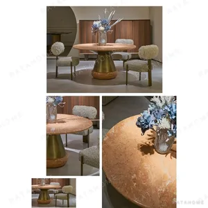 Orange Ice Jade Round Dining Table on Sculpted Stone Base in rust — in a room setting