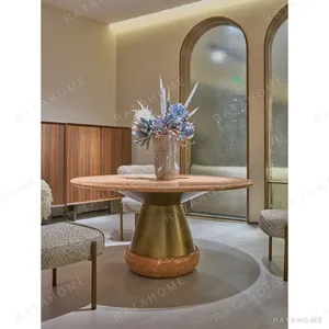 Orange Ice Jade Round Dining Table on Sculpted Stone Base in rust — in a room setting