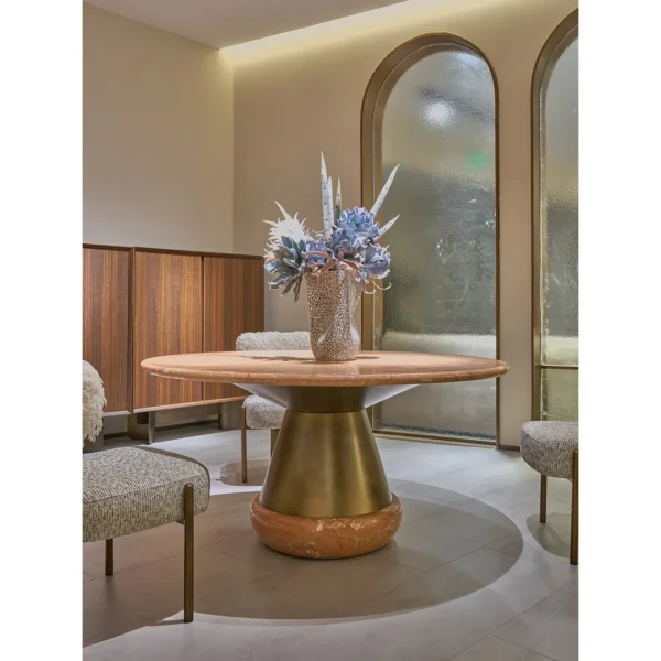 Orange Ice Jade Round Dining Table on Sculpted Stone Base in rust — in a room setting