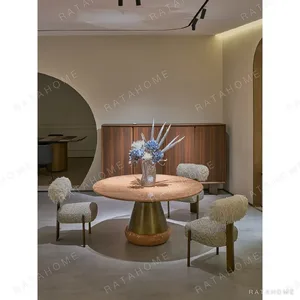Orange Ice Jade Round Dining Table on Sculpted Stone Base in rust — in a room setting