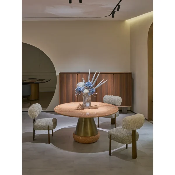 Orange Ice Jade Round Dining Table on Sculpted Stone Base in rust — in a room setting