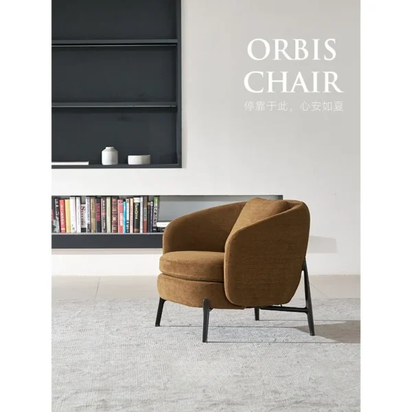 Curved Lounge Chair in Caramel Fabric on Slim Metal Legs — in a room setting
