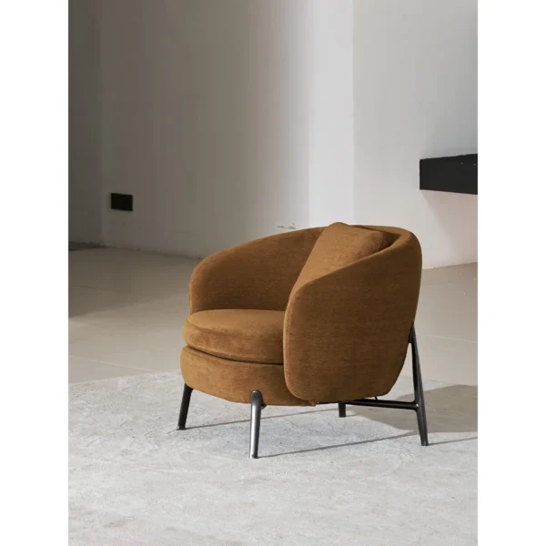 Curved Lounge Chair in Caramel Fabric on Slim Metal Legs — in a room setting