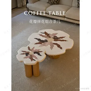 Petal Marble Marquetry Nesting Coffee Table Set in ivory — in a room setting