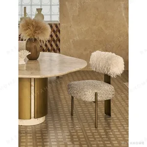 Free-Form Travertine Dining Table on Aged Brass Base in oatmeal — in a room setting