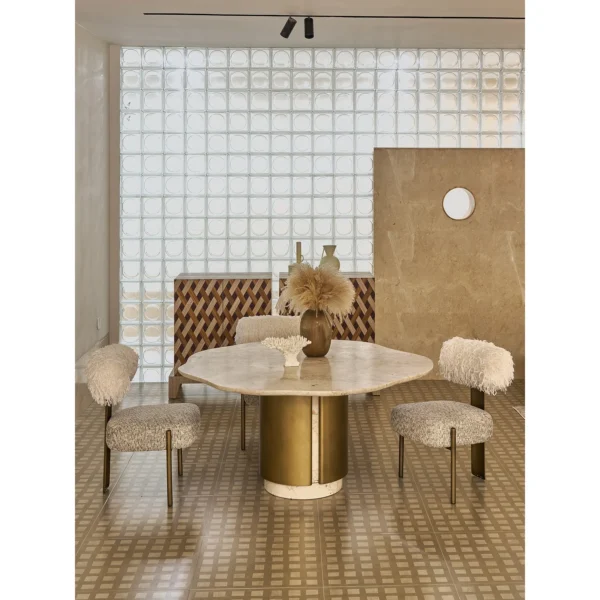 Free-Form Travertine Dining Table on Aged Brass Base in oatmeal — in a room setting