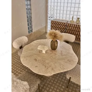 Free-Form Travertine Dining Table on Aged Brass Base in oatmeal — in a room setting