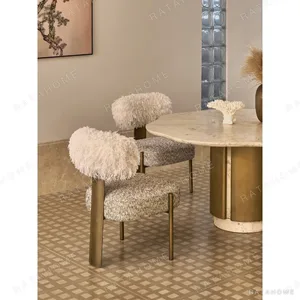 Free-Form Travertine Dining Table on Aged Brass Base in oatmeal — in a room setting