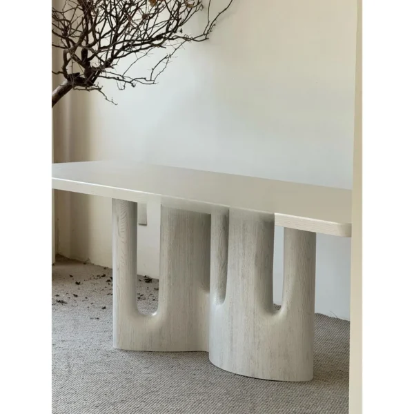 White Long Dining Table on Fluted Arch Base in ivory — in a room setting