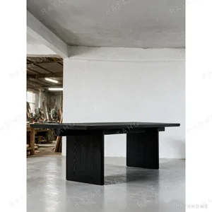 Otoko Black Ash Dining Table with Bridged Panel Legs in black — in a room setting