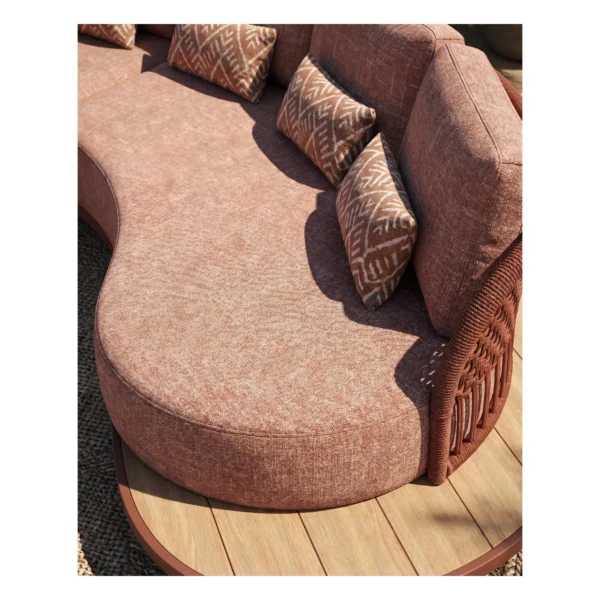 Outdoor Curved Rope Sofa in rust — in a room setting