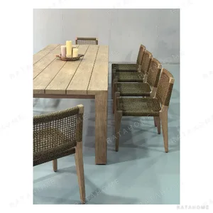 Weathered Teak Outdoor Long Table with Woven Rope Chairs in natural oak — in a room setting