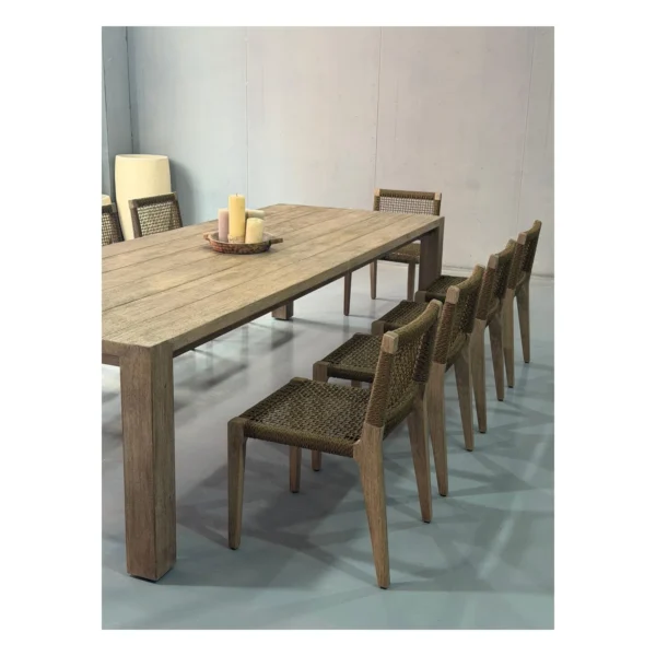 Weathered Teak Outdoor Long Table with Woven Rope Chairs in natural oak — in a room setting
