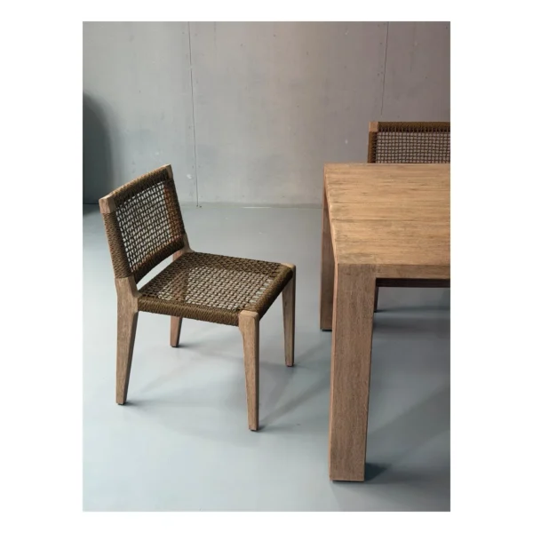 Weathered Teak Outdoor Long Table with Woven Rope Chairs in natural oak — in a room setting