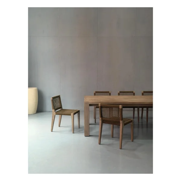 Weathered Teak Outdoor Long Table with Woven Rope Chairs in natural oak — in a room setting