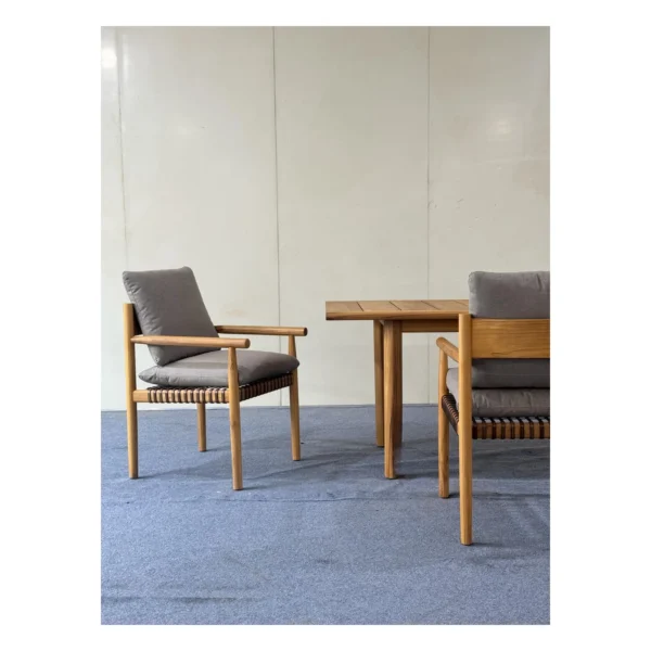 Lightweight Teak Outdoor Dining Set in natural oak — in a room setting