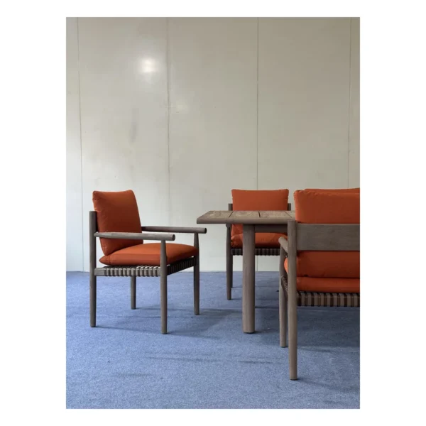 Lightweight Teak Outdoor Dining Set in natural oak — in a room setting