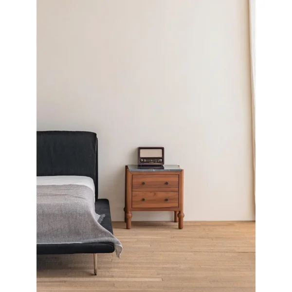 Panda Teak Nightstand with Stone Top and Ball Feet in clay — in a room setting