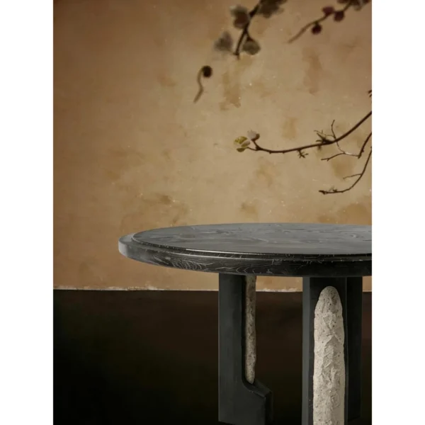 Panmu Round Black Table with Stone-Inset Base in black — in a room setting