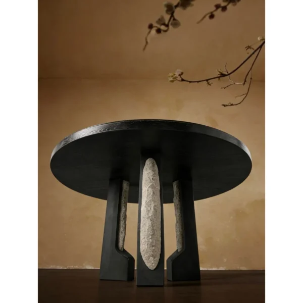 Panmu Round Black Table with Stone-Inset Base in black — in a room setting