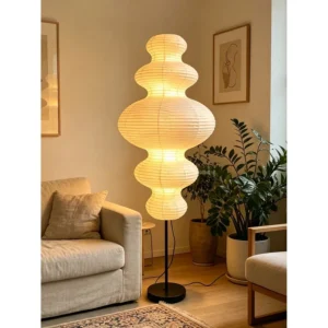 Pleated Paper Gourd Floor Lamp on Black Stem in oatmeal — in a room setting