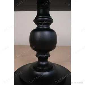 Inkstone Solid Wood Pedestal Table with Turned Old Wood Base in black — in a room setting