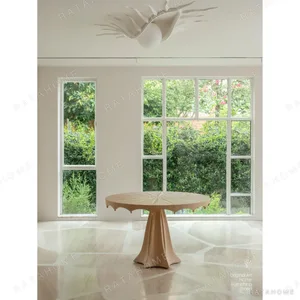 Petal Round Dining Table with Radiating Marquetry in sand — in a room setting