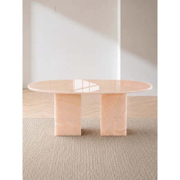 Pink Jade Oval Coffee Table with Gold Veining in rose stone — in a room setting