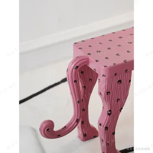 Pink Leopard Sculptural Bench in rose stone — in a room setting