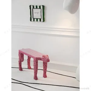 Pink Leopard Sculptural Bench in rose stone — in a room setting