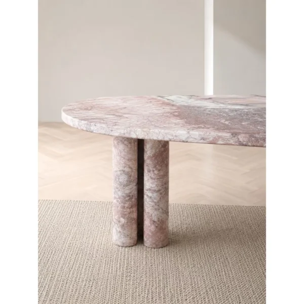 Pink-White Marble Oval Dining Table on Stone Cylinders in rose stone — in a room setting