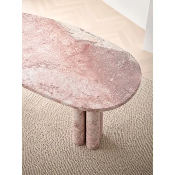 Pink-White Marble Oval Dining Table on Stone Cylinders in rose stone — in a room setting