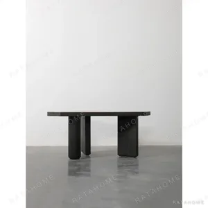 Polygonal Marble-Inset Low Table on Black Wood Legs in black — in a room setting