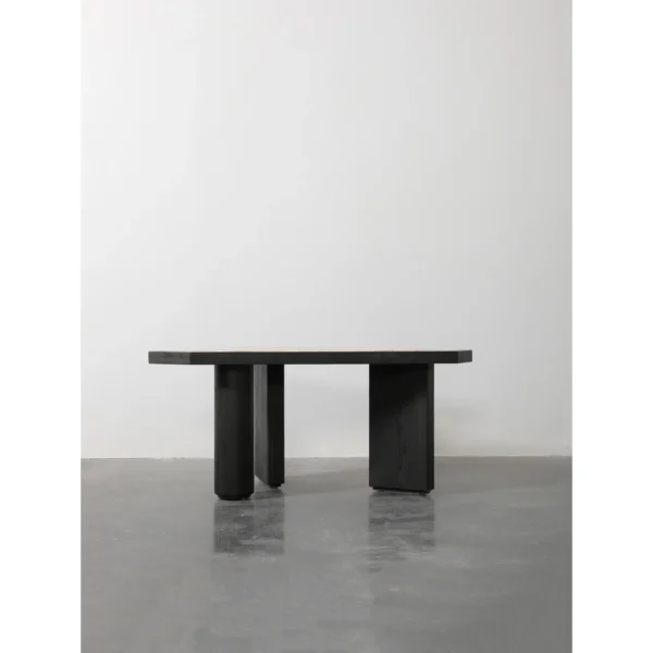 Polygonal Marble-Inset Low Table on Black Wood Legs in black — in a room setting