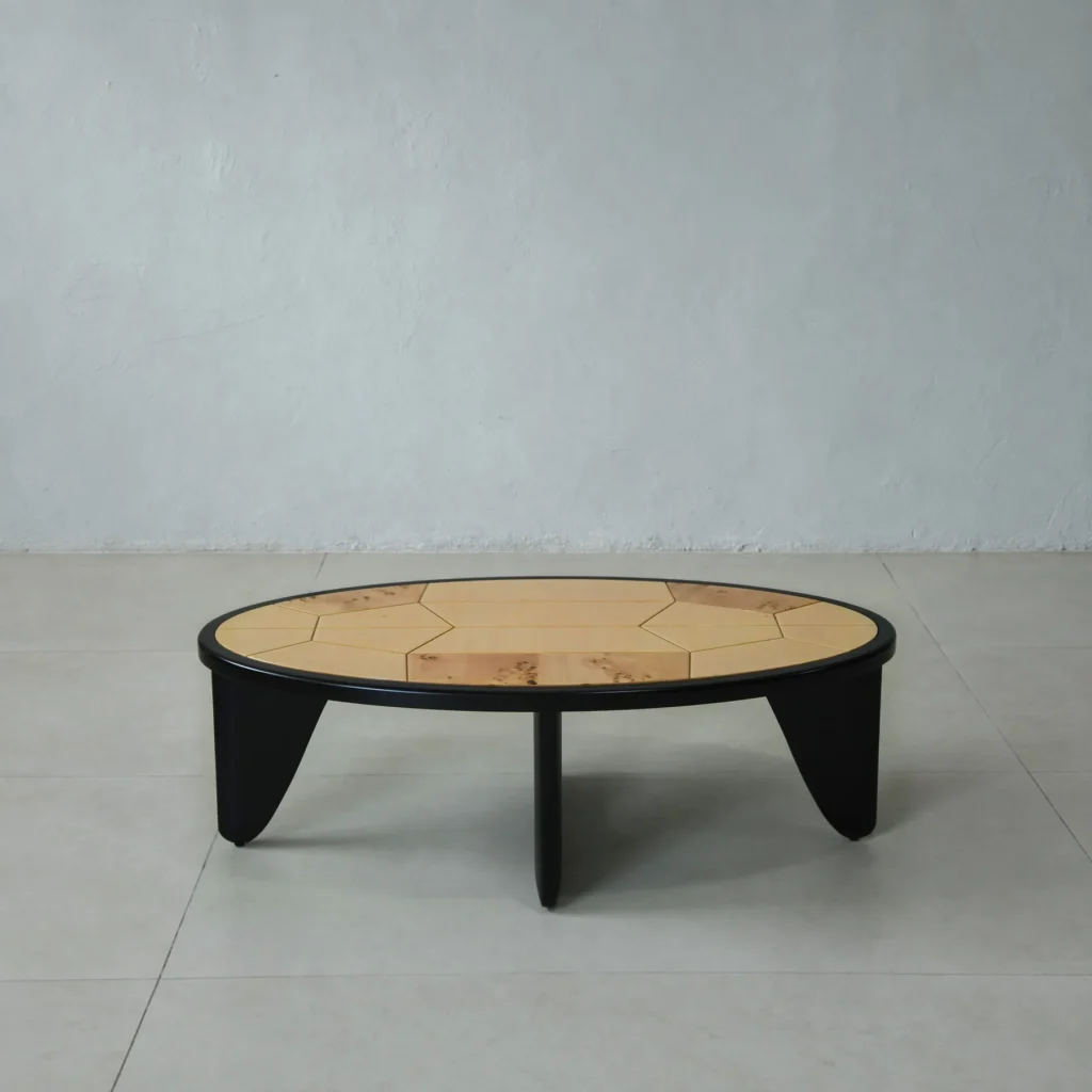 Round Poplar Burl Segmented Coffee Table on Black Beech Base in clay — front view