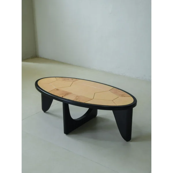 Round Poplar Burl Segmented Coffee Table on Black Beech Base in clay — in a room setting