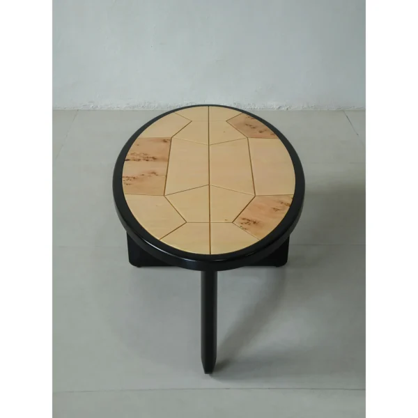 Round Poplar Burl Segmented Coffee Table on Black Beech Base in clay — in a room setting