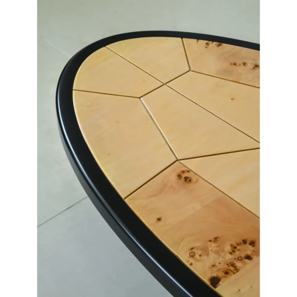 Round Poplar Burl Segmented Coffee Table on Black Beech Base in clay — in a room setting
