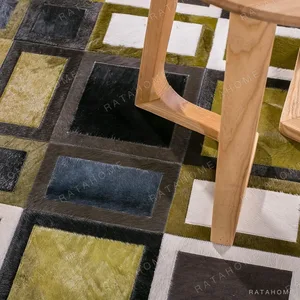Premium Cowhide Grid Rug in Olive, Black and Cream — in a room setting