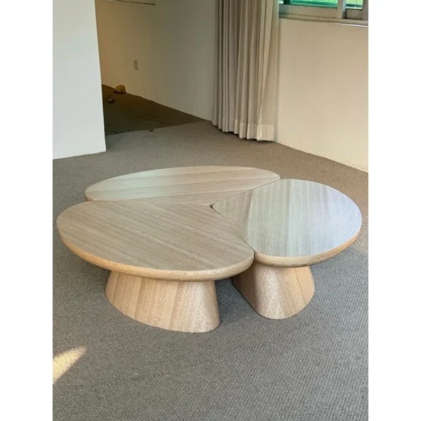 Petal Three-Piece Round Coffee Table in natural oak — in a room setting