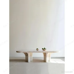 Pushi Raw Stone Dining Table with Block-Built Base in oatmeal — in a room setting