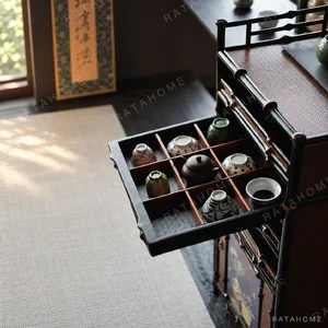 Qingyu Bamboo Apothecary Cabinet with Painted Floral Doors in black — in a room setting